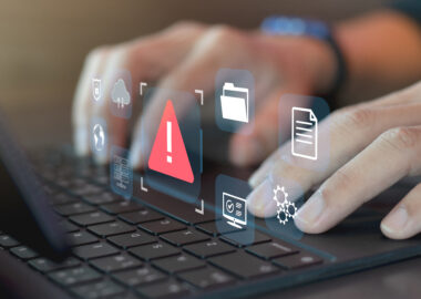 Developer programmer using laptop with warning triangle sign for alert found error and maintenance concept